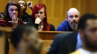 Mandi Marie (centre) sits in the courtroom with family members during the preliminary examination of four defendants in the beating of her father Steve Utash after he accidentally struck a child with his truck in Detroit, Michigan 21 April 2014
