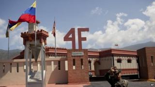 A soldier stands guard at a former century-old military barracks where the late Hugo Chavez commanded a failed 1992 coup