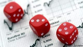 Three dice on stock market graphs
