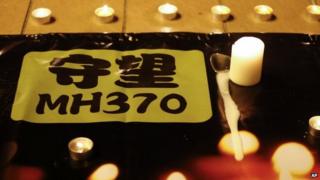 A banner is displayed during a candlelight vigil for passengers onboard the missing Malaysia Airlines Flight MH370, in Kuala Lumpur, Malaysia, on 7 April 2014
