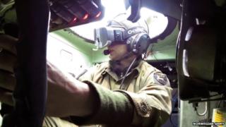 Soldier in a tank wearing Oculus headset