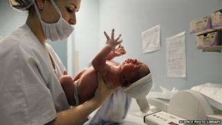 A baby being weighed