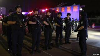 Members of the Special Weapons and Tactics (SWAT) team stand in formation as they gather during an anti-terrorism drill in Beijing, 8 May 2014