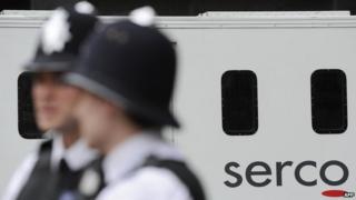 police standing in front of a Serco van