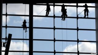 Labourers work at the new terminal at Guarulhos International airport in Sao Paulo, May 2014