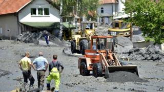 Mechanical diggers clean streets in village of Topcic Polje, damaged in a landslide, near Bosnian town of Zenica. 19 May 2014