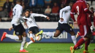 Nathan Redmond of England scores
