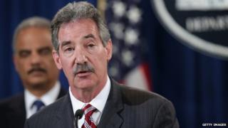 US Deputy Attorney General James Cole (centre) speaks as Attorney General Eric Holder (L) listens during a news conference at the Justice Department in Washington DC 19 May 2014