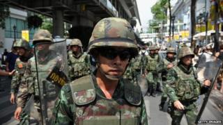 Thai army soldiers move out from a city centre anti-coup rally on 25 May 2014 in Bangkok, Thailand