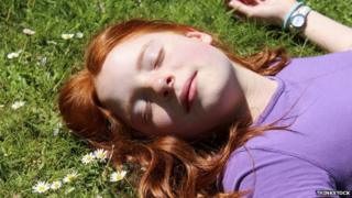 Woman asleep in meadow