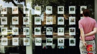 A man looks in a London estate agents window