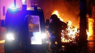Police stand near burning containers during a protest against the eviction of squatters from the Can Vies building in the Sants neighbourhood of Barcelona