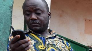 A shopkeeper using a mobile phone in Bangui, CAR - April 2014