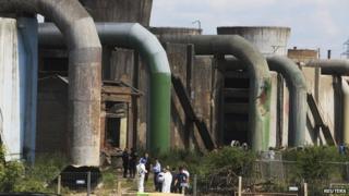 Forensic experts inspect the site of a explosion at Kosova A power plant in Obilic near Pristina on 6 June 2014.