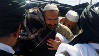 Man believed to be Mohammad Nabi Omari being welcomed at an undisclosed location in Qatar (1 June 2014)