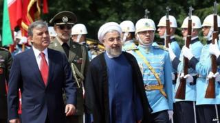 Abdullah Gul (left) and Hassan Rouhani (centre) in Ankara (9 June 2014)