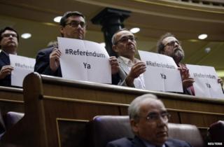 Plural Left MPs hold up placards in parliament calling for a referendum, 11 June