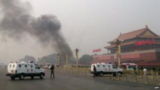 File photo: Police cars blocking off the roads leading into Tiananmen Square as smoke rises into the air after a vehicle loaded with petrol crashed in front of Tiananmen Gate in Beijing, 28 October 2013