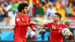 Marouanne Fellaini and Dries Mertens celebrate as Belgium beat Algeria 2-1 at the 2014 Fifa World Cup in Brazil .