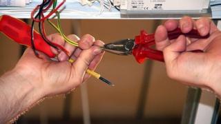 Electrician repairing strip light
