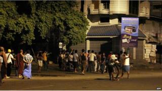 An angry mob take to the streets of Mandalay in central Myanmar early on 2 July 2014