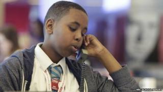 Student researches a news story on the phone