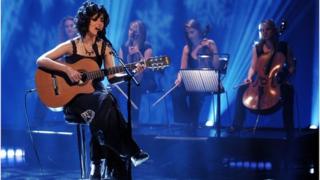 Katie Melua singing with guitar