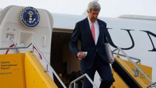US Secretary of State John Kerry disembarks from his plane after arriving in Vienna