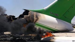 Flames and smoke billowing from an airplane at the Tripoli international airport in the Libyan capital, 16 July 2014