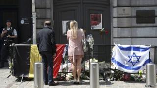 A couple looks at tributes outside the Jewish Museum in Brussels - 1 June 2014