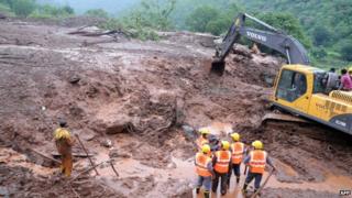 Rain is hampering efforts to search for scores of people presumed trapped under the mud and debris