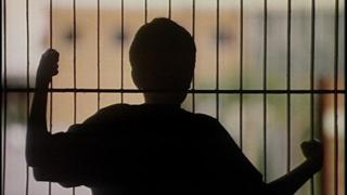Boy behind bars