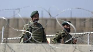 Afghanistan National Army soldiers stand guard at a gate of Camp Qargha, west of Kabul, Afghanistan 5 August 2014