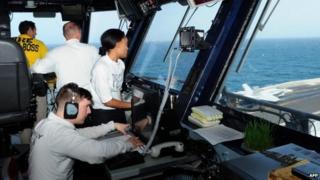 Crew of the USS George H W Bush in the Persian Gulf watch F/A-18 Hornet take off (27 June 2014)