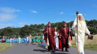 Dyfrig ab Ifor, yr Arwyddfardd, yn arwain y ffordd at Feini'r Orsedd