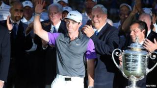 Rory McIlroy posing with trophy