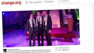 Three boys wearing Palestinian scarves