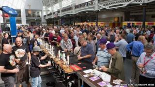 Attendees enjoying and tasting different types of beer at the Great British Beer Festival