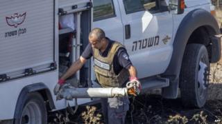 Israeli bomb disposal expert collects remains of rocket fired by Gaza militants 29/07/2014