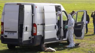 Chilean police inspect a vehicle which was used to in the robbery, August 12, 2014.
