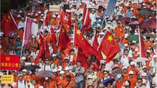 Pro-China protestors, opponents of the pro-democracy "Occupy Central" movement, march through the streets of Central District, Hong Kong, China, 17 August 2014.