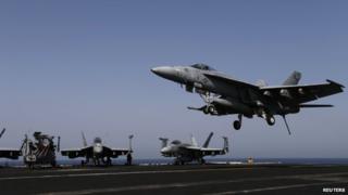 A F/A-18E Super Hornet of Strike Fighter Squadron (VFA-31) comes in to land onboard the flight deck of the aircraft carrier USS George HW Bush (CVN 77), in the Gulf 12 August 2014