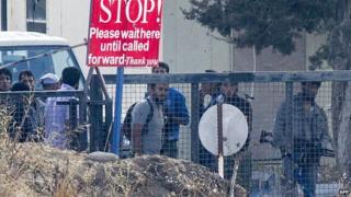 Armed men, reportedly rebel fighters, standing on the Syrian side of the Golan, at the Quneitra border crossing, on 29 August 2014.