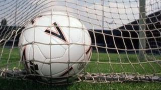 football in a goal net.