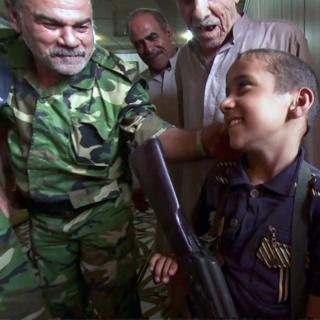 Ali and a boy with a gun