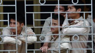 This picture taken on 29 November 2013 shows drug addict inmates watching a music concert named 'Bringing music into hospitals' organised by a group of local artists to mark the World Aids Day at an official centre for treatment of drug addicts in Hanoi.