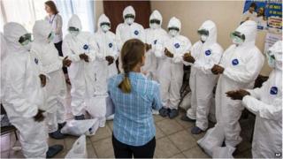 A World Health Organization worker trains nurses to use Ebola protective gear in Freetown, Sierra Leone