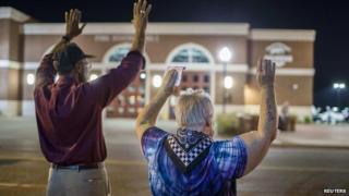 Protesters gather across street from Ferguson police department. 27 Sept 2014