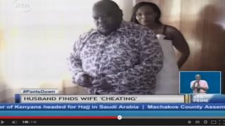 A man and woman putting their clothes on.