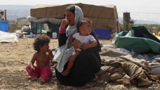 Syrian refugee rest with belongings in Halba, Akkar district of Lebanon (24 September 2014)